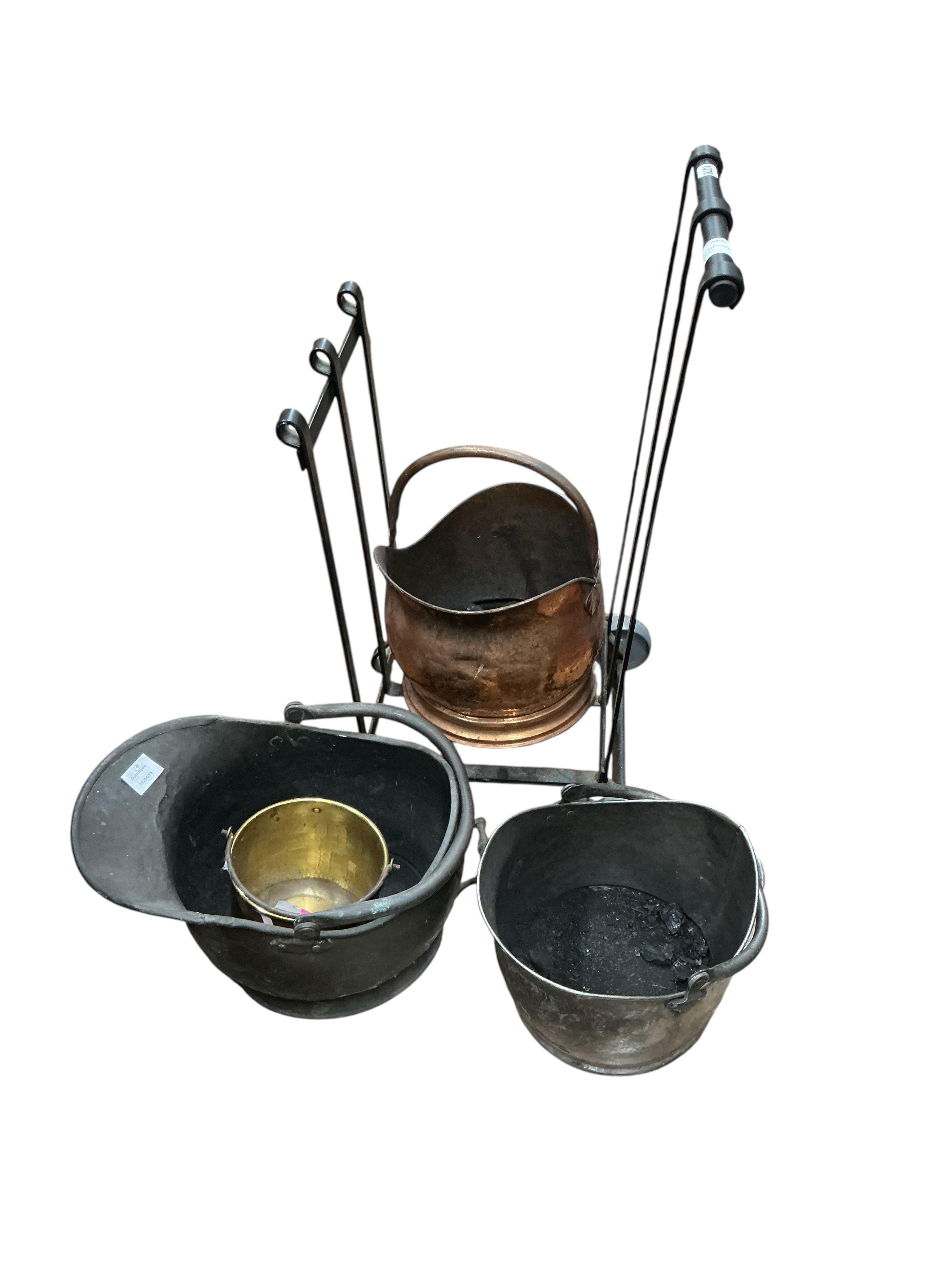 A wrought iron log stand, three copper and iron coal scuttles and a small brass pail
